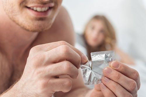 bigstock Man Opening Condom 200330416