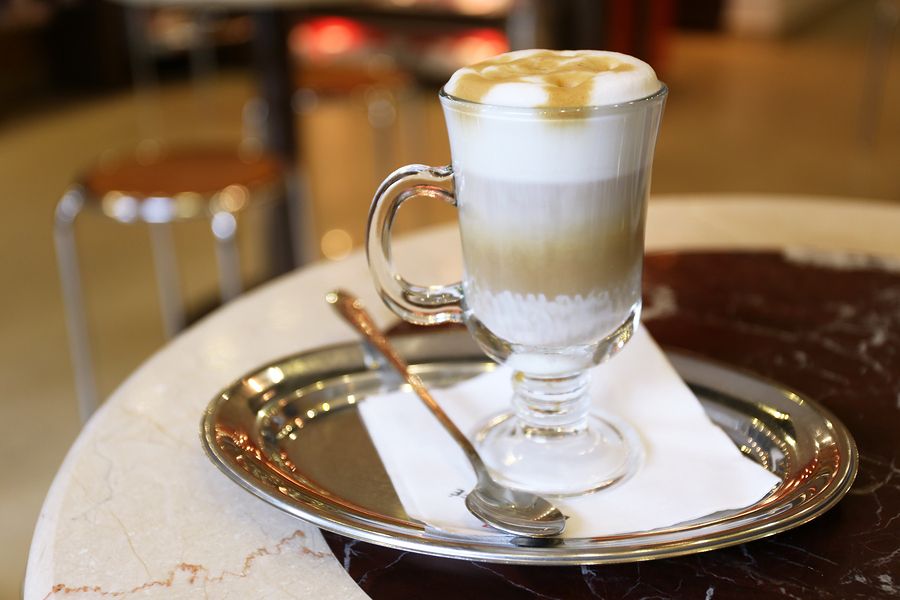 bigstock Glass of latte coffee on metal 98229410