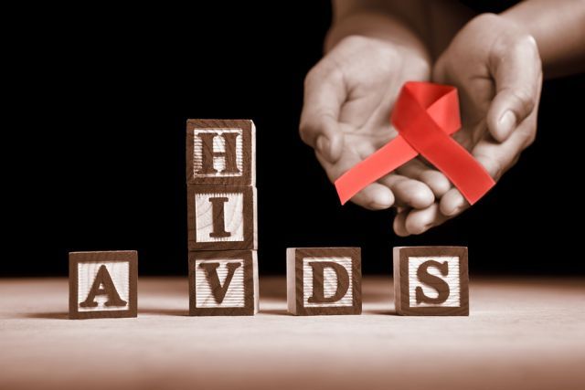bigstock Hand holding red ribbon on bac 28926392