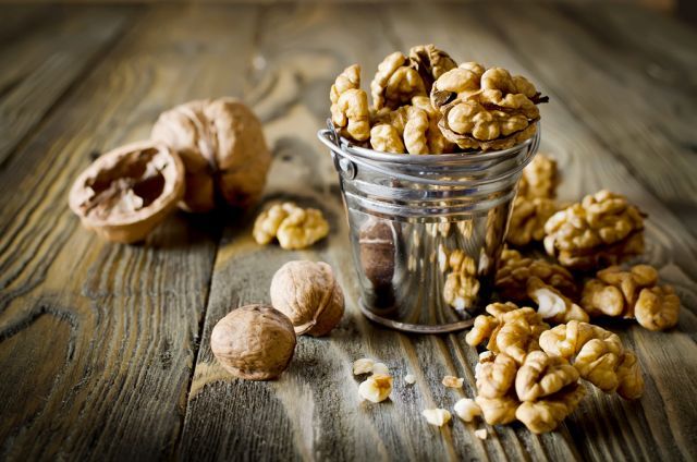 bigstock Walnut Kernels And Whole Walnu 88157450