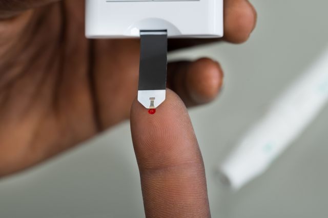 bigstock Patient Hands With Glucometer 94941767