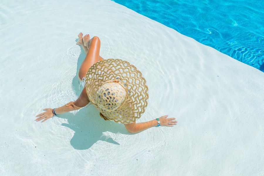 bigstock Woman sitting in a swimming po 119796536