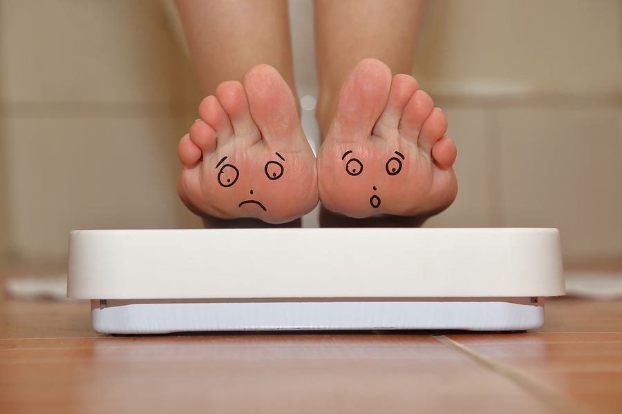 bigstock Feet on bathroom scale with ha 83218232