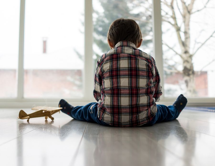 bigstock Sad kid sitting on floor 85418261