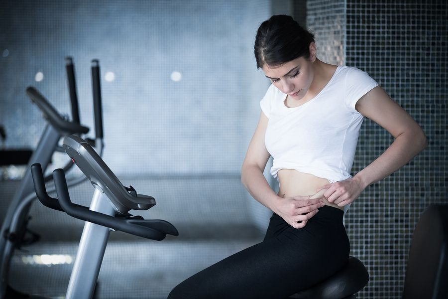 bigstock Woman riding an exercise bike 90814484