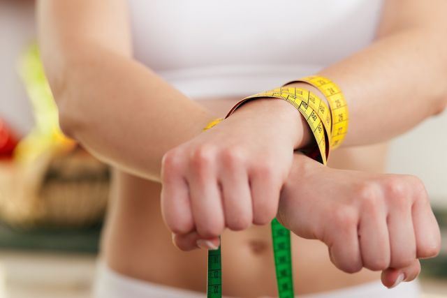 bigstock Dieting gone wild Woman hand 10165592