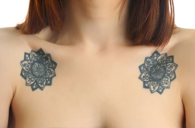 bigstock Flower tattoos on female shoul 115450928