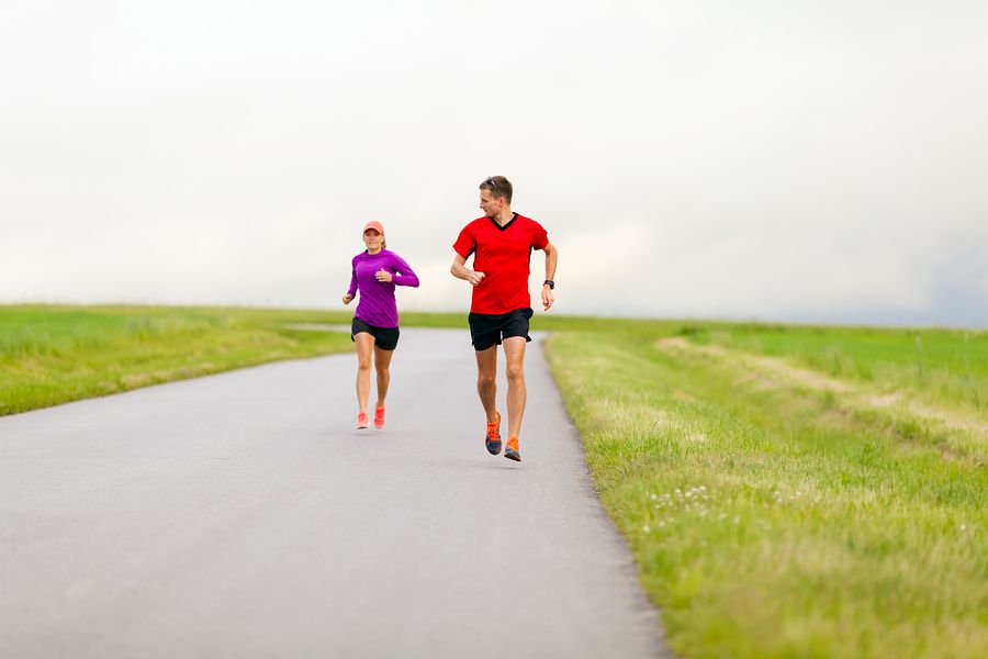 bigstock Couple Running On Country Road 97301933