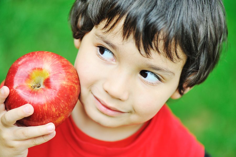 bigstock Cute kid holding red apple 15439349