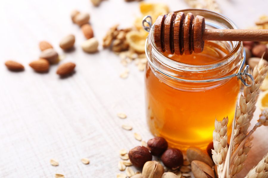 bigstock Honey in glass jar and nuts C 103147982