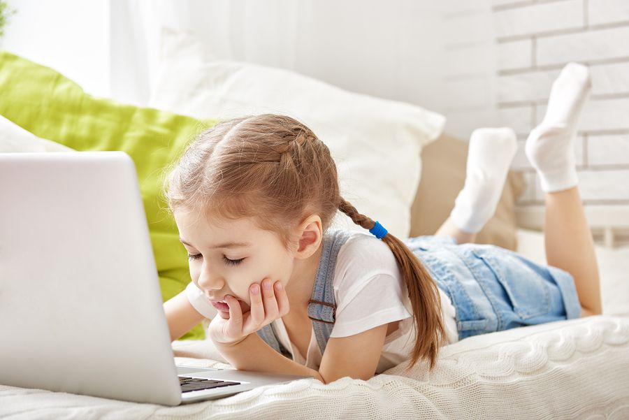 bigstock Child little girl with a lapto 116447630