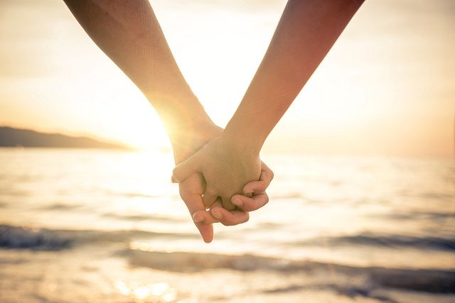 bigstock Couple Holding Hands At Sunset 91139126