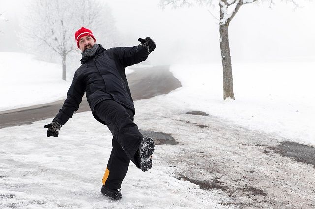 bigstock Man Is Slipping On A Icy Road 102707804