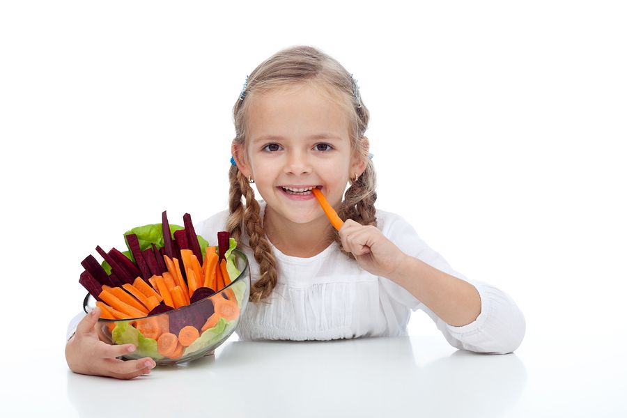bigstock Little girl munching on a carr 24954971