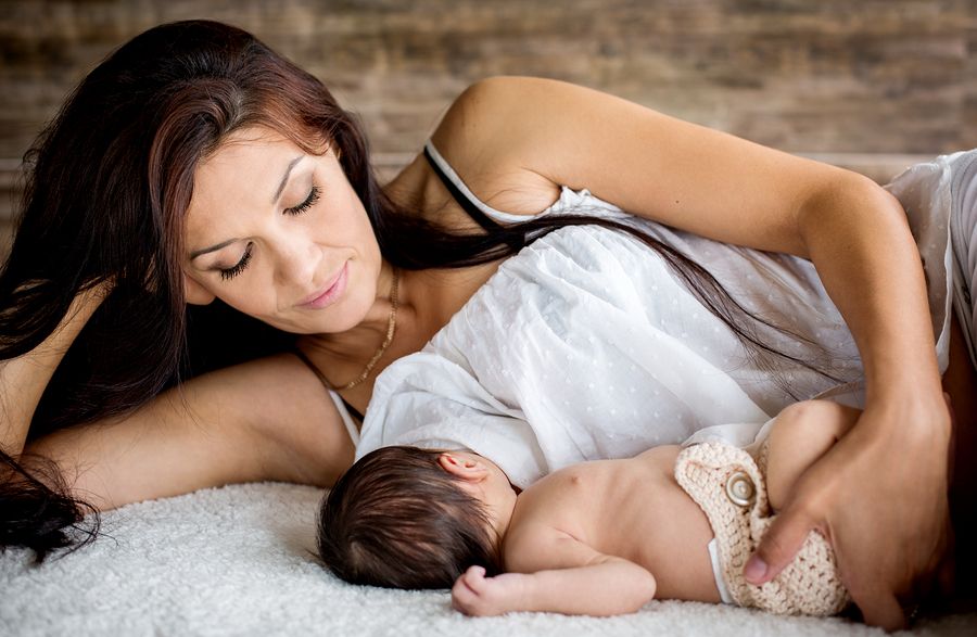 bigstock Beautiful Mother Feeding Her N 74667802