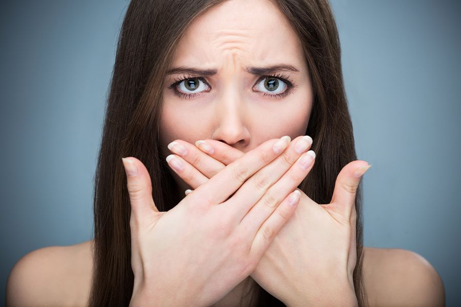 bigstock Woman covering mouth 85655465