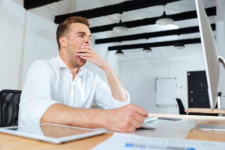 bigstock Sleepy tired young businessman 139717727