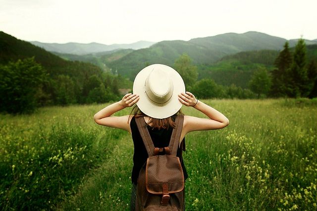 bigstock Woman Traveler With Backpack H 168494492