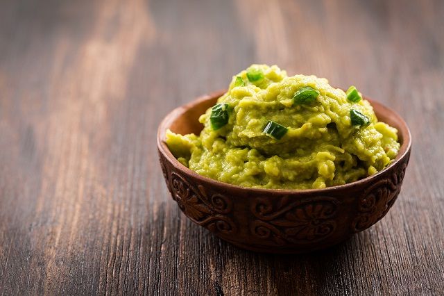 bigstock Guacamole on wooden table 183451909