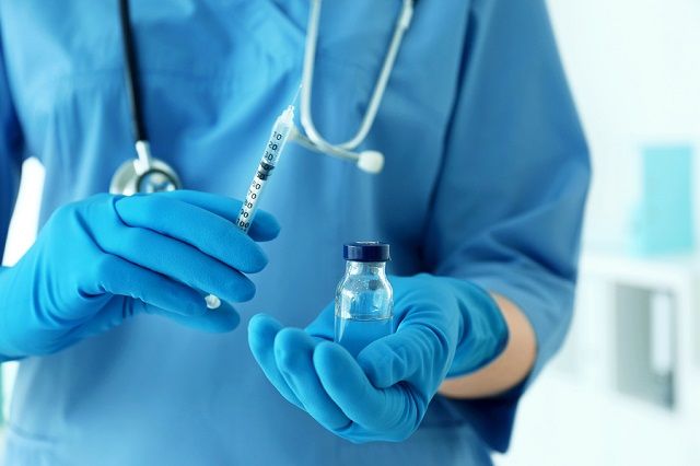 bigstock Nurse with syringe and medicin 181648147