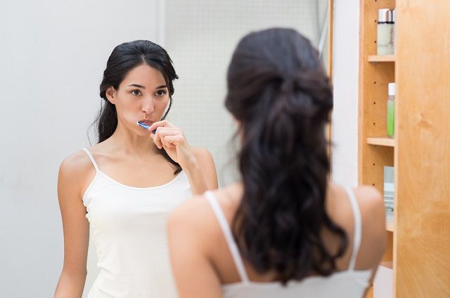 bigstock Attractive woman brushing teet 174698263