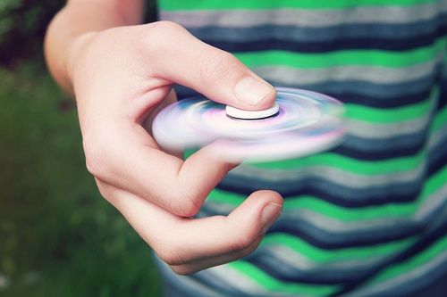 bigstock Teen boy with a fidget spinner 187832617