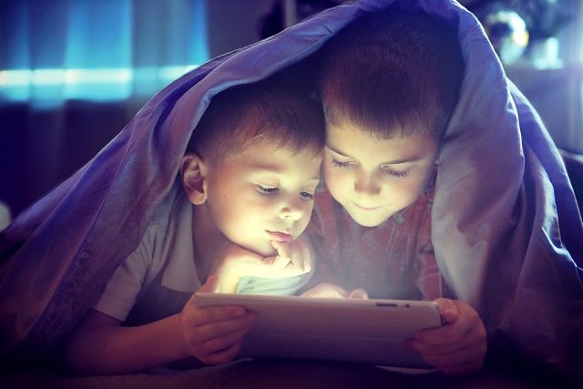 bigstock Two kids using tablet pc under 107656520