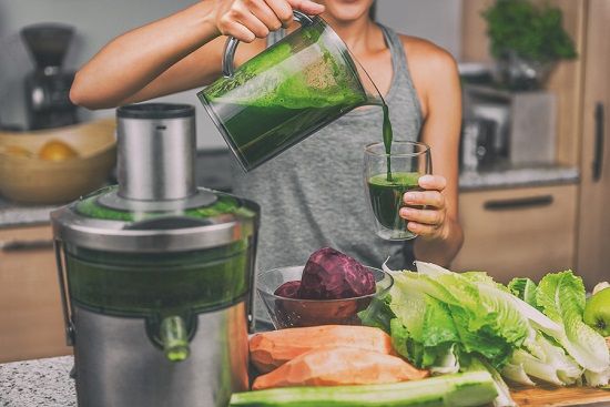 bigstock Woman juicing making green jui 206212198