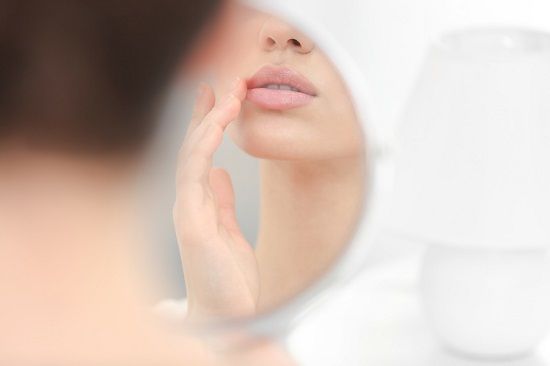 bigstock Young woman with cold sore loo 175720762