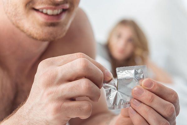 bigstock Man Opening Condom 200330416