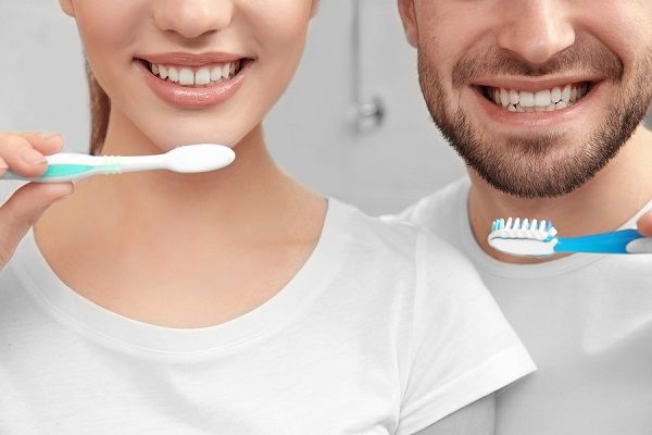 bigstock Young happy couple brushing te 189085477