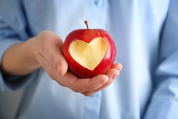 bigstock Woman hand holding fresh red a 178391590