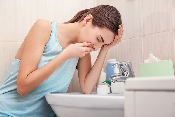 bigstock Young vomiting woman near sink 178963153