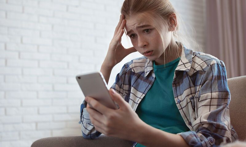 bigstock Shocked Teenage Girl With Smar 305198365