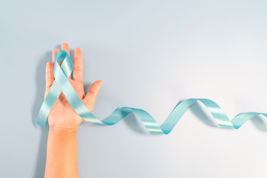 Prostate Cancer Awareness Campaign Concept, Men's Health Concept. Hand Holding Light Blue Ribbon Lon