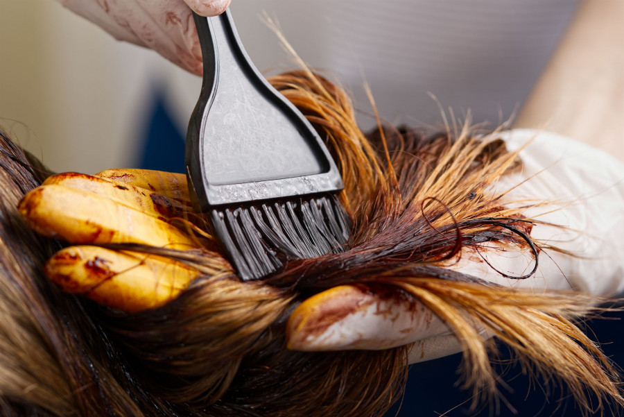 Young Female Hairdressed Hands Dyeing Long Hair To Beautiful Girl. Barber Hair Dye Is Applied With A
