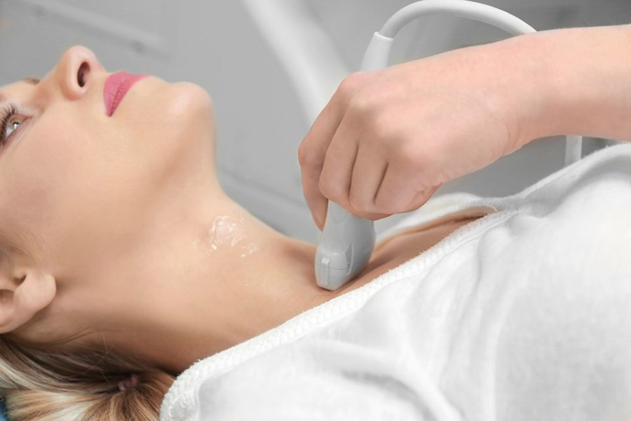 Young woman undergoing ultrasound scan in modern clinic
